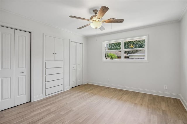 3313 Clifford Dr, Metairie, LA 70002 - unfurnished bedroom with two closets, light wood-type flooring, baseboards, crown molding, and ceiling fan