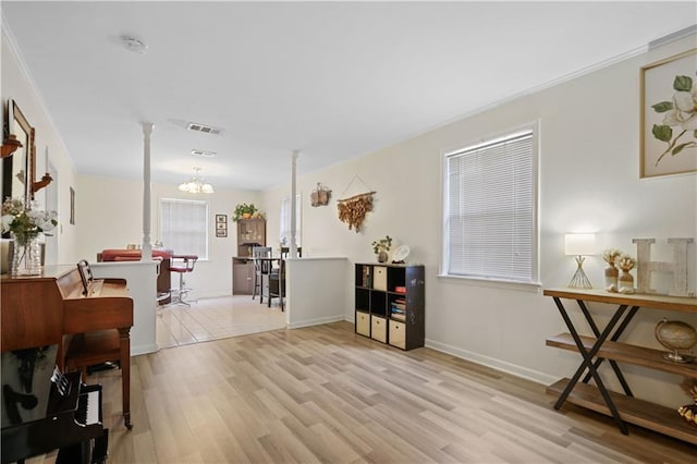 2529 Hudson Pl, New Orleans, LA 70131 - living area featuring a chandelier, light wood-style flooring, ornamental molding, and baseboards