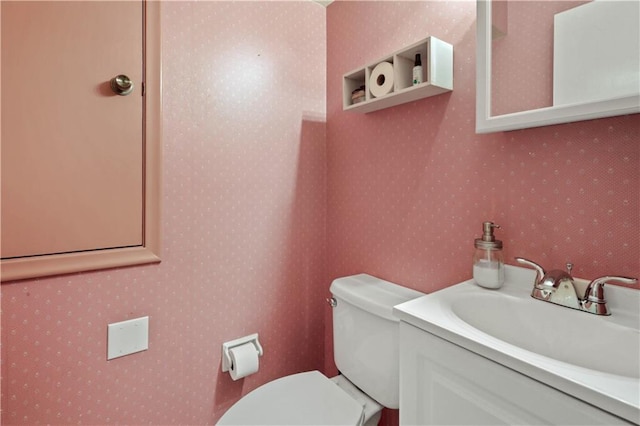 2529 Hudson Pl, New Orleans, LA 70131 - bathroom featuring toilet, wallpapered walls, and vanity