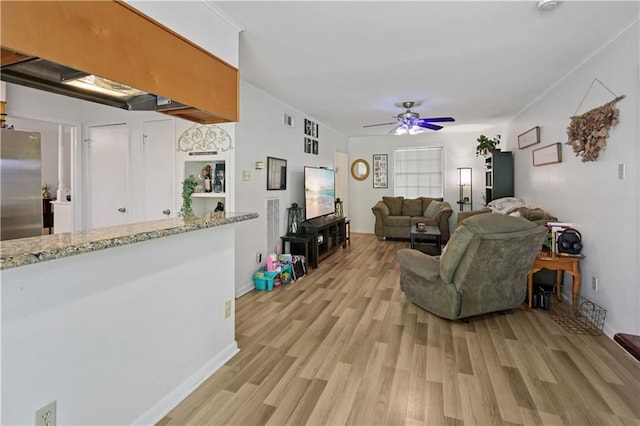 2529 Hudson Pl, New Orleans, LA 70131 - living room with light wood-style flooring, ceiling fan, ornamental molding, and baseboards