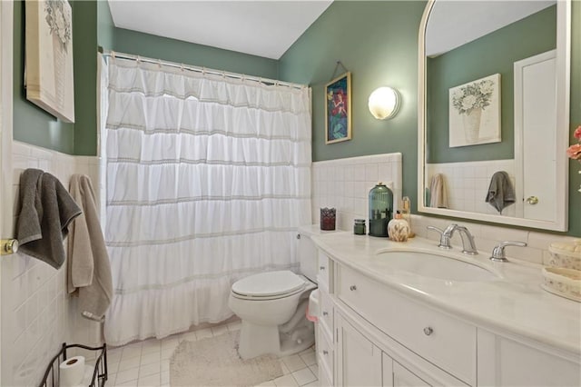 2529 Hudson Pl, New Orleans, LA 70131 - bathroom featuring tile walls, toilet, tile patterned flooring, vanity, and a wainscoted wall