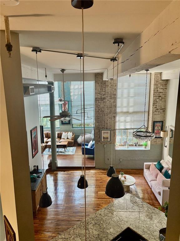920 Poeyfarre St Unit 264, New Orleans, LA 70130 - living area with hardwood / wood-style flooring and healthy amount of natural light