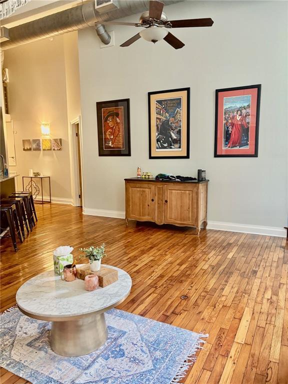 920 Poeyfarre St Unit 264, New Orleans, LA 70130 - living area with light wood-style floors, high vaulted ceiling, baseboards, and a ceiling fan