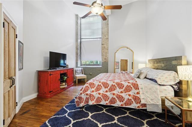 920 Poeyfarre St Unit 264, New Orleans, LA 70130 - bedroom featuring high vaulted ceiling, wood finished floors, baseboards, and ceiling fan