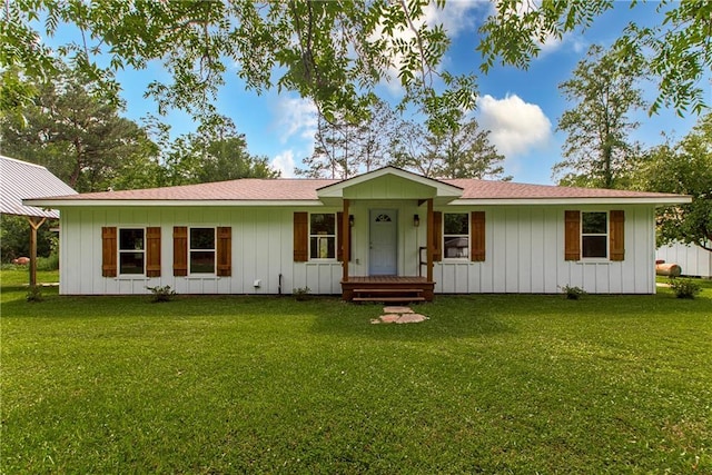51075 Jenkins Ln, Tickfaw, LA 70466 - single story home featuring board and batten siding, a front yard, and roof with shingles