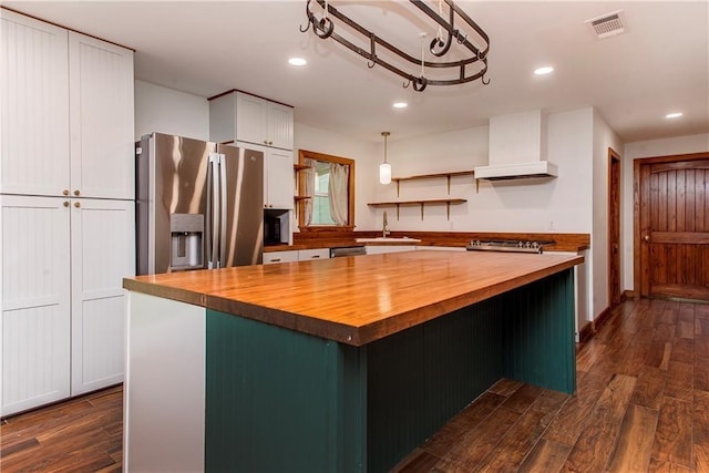 51075 Jenkins Ln, Tickfaw, LA 70466 - kitchen featuring butcher block countertops, appliances with stainless steel finishes, a sink, recessed lighting, and a kitchen island
