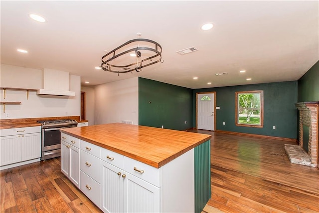 51075 Jenkins Ln, Tickfaw, LA 70466 - kitchen with wooden counters, stainless steel stove, white cabinets, open shelves, and recessed lighting