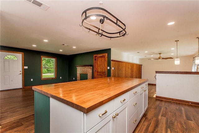 51075 Jenkins Ln, Tickfaw, LA 70466 - kitchen with wood counters, white cabinets, open floor plan, baseboards, and recessed lighting