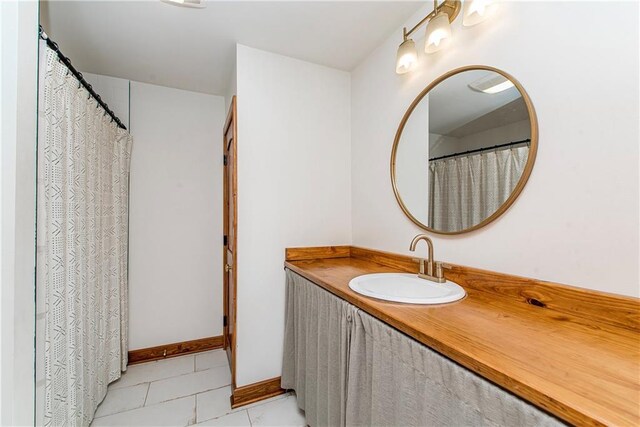 51075 Jenkins Ln, Tickfaw, LA 70466 - full bath with vanity, tile patterned floors, and baseboards