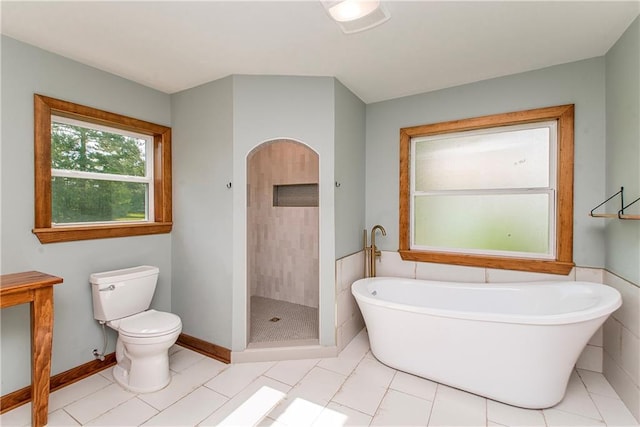 51075 Jenkins Ln, Tickfaw, LA 70466 - bathroom featuring toilet, a soaking tub, a shower stall, and tile patterned floors