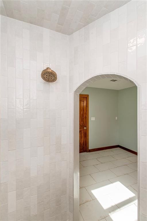 51075 Jenkins Ln, Tickfaw, LA 70466 - spare room with arched walkways and light tile patterned floors