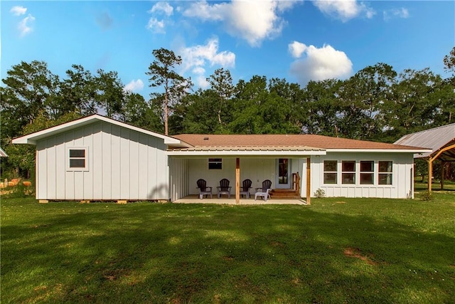 51075 Jenkins Ln, Tickfaw, LA 70466 - back of house featuring a patio area, a yard, and board and batten siding