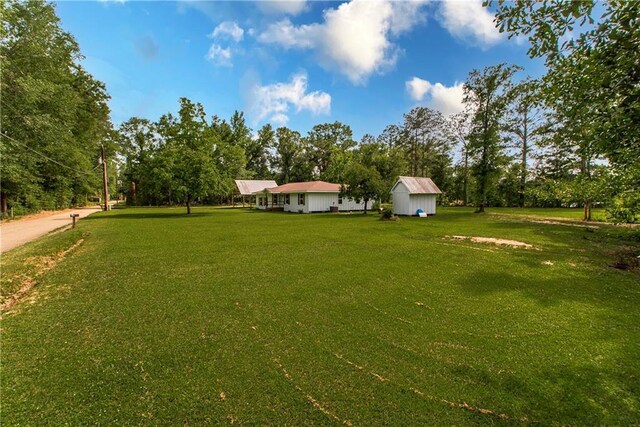 51075 Jenkins Ln, Tickfaw, LA 70466 - view of grassy yard featuring view of wooded area