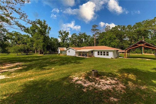 51075 Jenkins Ln, Tickfaw, LA 70466 - rear view of house featuring a yard, a detached carport, a gazebo, and view of scattered trees