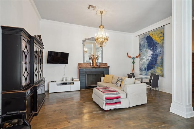 2539 N Rampart St, New Orleans, LA 70117 - living area with crown molding, a chandelier, dark wood-style flooring, and ornate columns