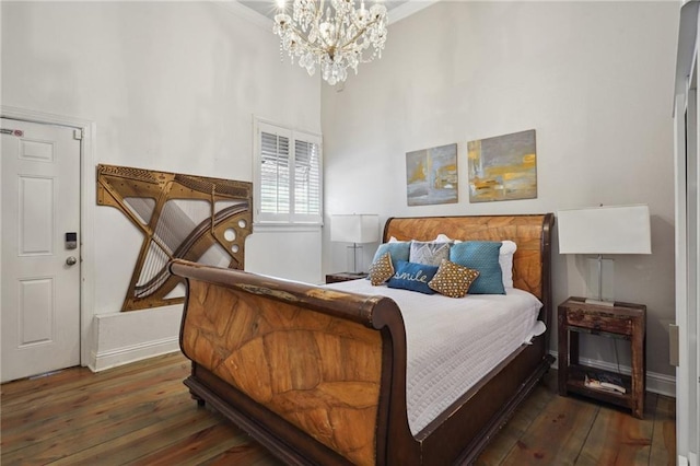 2539 N Rampart St, New Orleans, LA 70117 - bedroom with wood-type flooring, a chandelier, and a towering ceiling