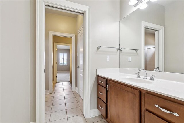 6919 Memphis St, New Orleans, LA 70124 - bathroom with tile patterned flooring, baseboards, and vanity