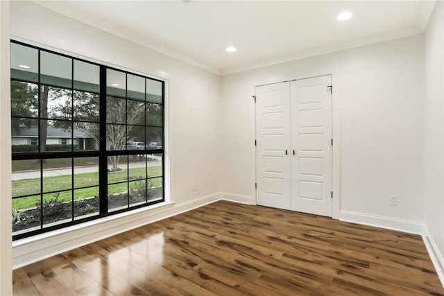 25 Woodvine Ct, Covington, LA 70433 - empty room featuring wood finished floors, ornamental molding, baseboards, and recessed lighting