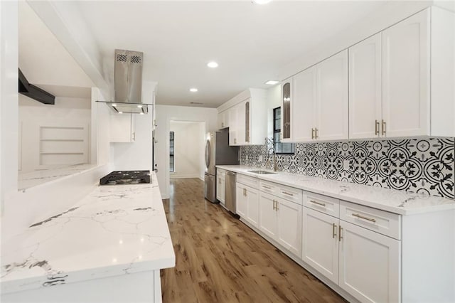 25 Woodvine Ct, Covington, LA 70433 - kitchen featuring island range hood, appliances with stainless steel finishes, white cabinetry, tasteful backsplash, and recessed lighting