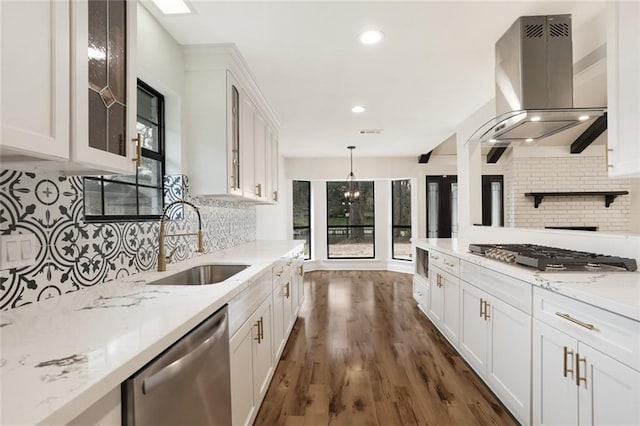 25 Woodvine Ct, Covington, LA 70433 - kitchen featuring appliances with stainless steel finishes, island exhaust hood, a sink, glass insert cabinets, and decorative backsplash