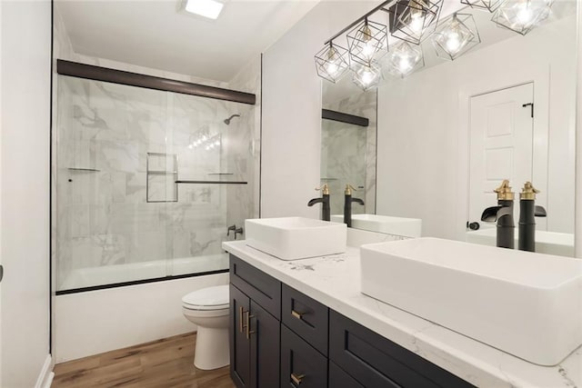 25 Woodvine Ct, Covington, LA 70433 - full bathroom with toilet, shower / bath combination with glass door, wood finished floors, and double vanity