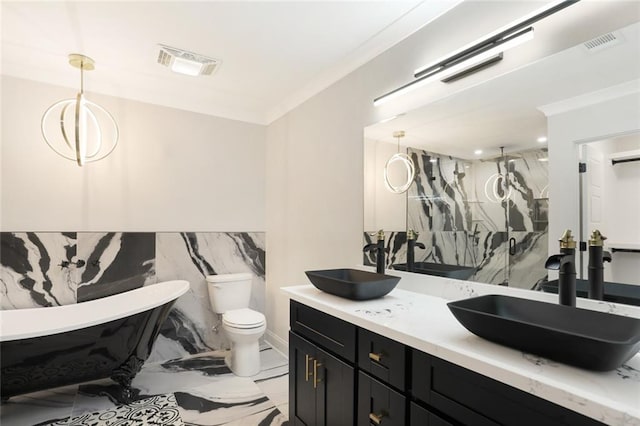 25 Woodvine Ct, Covington, LA 70433 - full bath with double vanity, a freestanding tub, marble finish flooring, a marble finish shower, and toilet