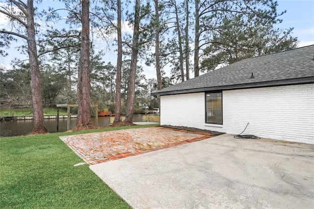 25 Woodvine Ct, Covington, LA 70433 - view of grassy yard featuring a patio area and a water view