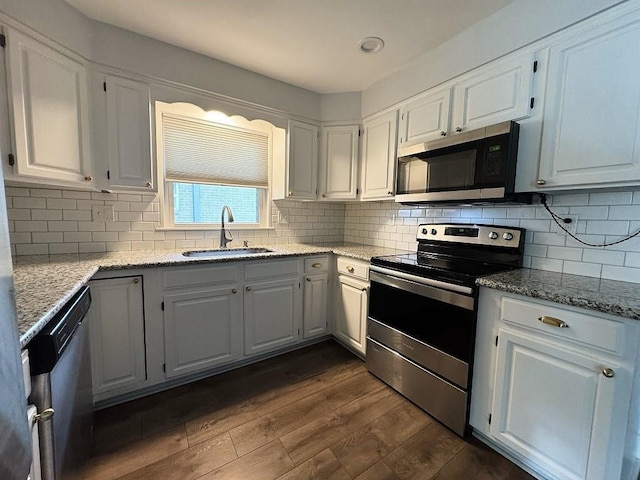 3609 Green Acres Rd, Metairie, LA 70003 - kitchen with appliances with stainless steel finishes, a sink, dark wood finished floors, and white cabinets