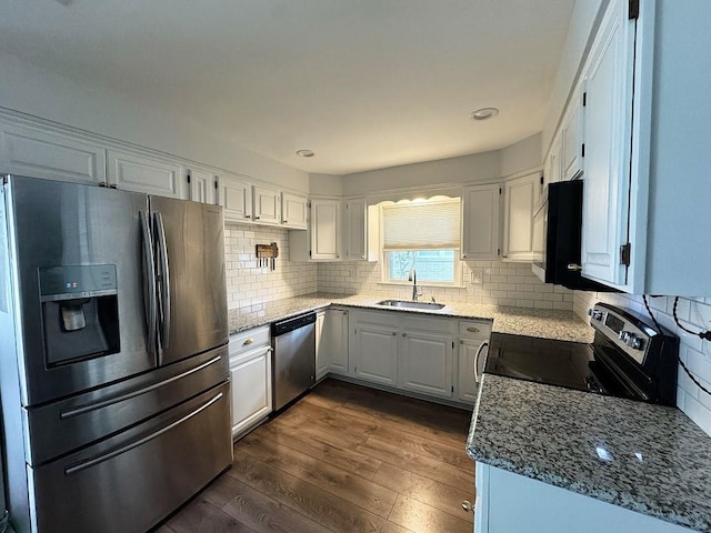 3609 Green Acres Rd, Metairie, LA 70003 - kitchen featuring appliances with stainless steel finishes, a sink, dark wood finished floors, light stone counters, and recessed lighting