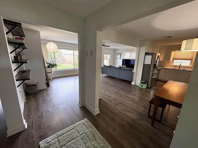 3609 Green Acres Rd, Metairie, LA 70003 - hall with baseboards, dark wood finished floors, and a sink
