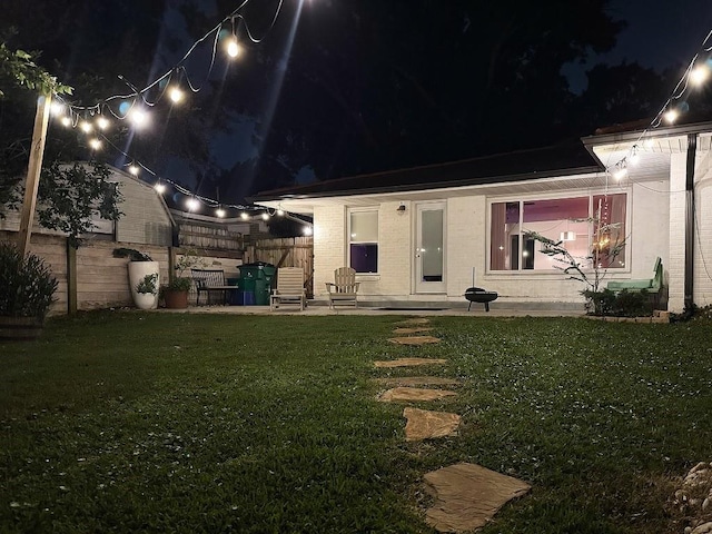 3609 Green Acres Rd, Metairie, LA 70003 - back of house at twilight featuring brick siding