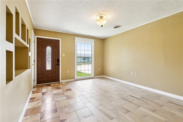 2412 Riverbend Dr, Violet, LA 70092 - foyer featuring a textured ceiling and baseboards