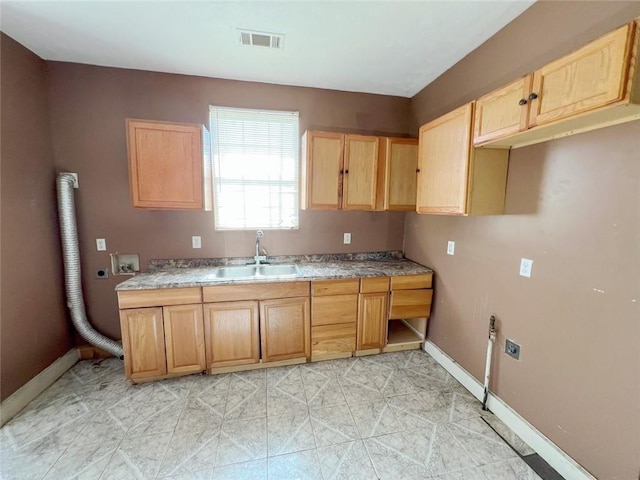 233436 N Miro St, New Orleans, LA 70117 - kitchen featuring a sink, light brown cabinets, baseboards, and light countertops
