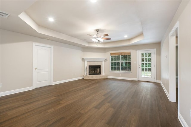 3133 Terrace Ave, Slidell, LA 70458 - unfurnished living room with a tray ceiling, ceiling fan, dark wood-style floors, a brick fireplace, and recessed lighting