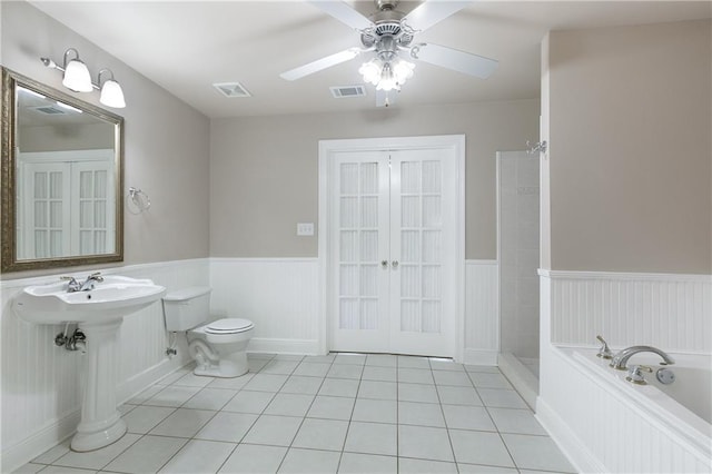 3133 Terrace Ave, Slidell, LA 70458 - bathroom featuring tile patterned floors, a wainscoted wall, a shower, french doors, and ceiling fan