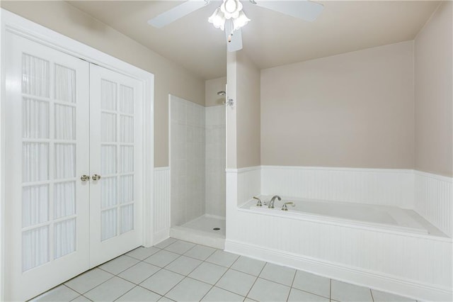 3133 Terrace Ave, Slidell, LA 70458 - full bathroom with a bath, tile patterned flooring, a tile shower, french doors, and wainscoting