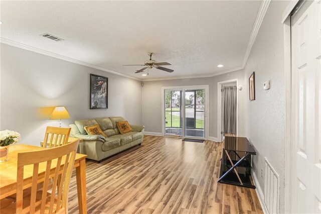 201 Avant Garde Cir Unit 201, Kenner, LA 70065 - living room featuring ornamental molding, light wood finished floors, a textured ceiling, ceiling fan, and recessed lighting