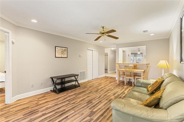 201 Avant Garde Cir Unit 201, Kenner, LA 70065 - living area with a ceiling fan, wood finished floors, recessed lighting, baseboards, and crown molding