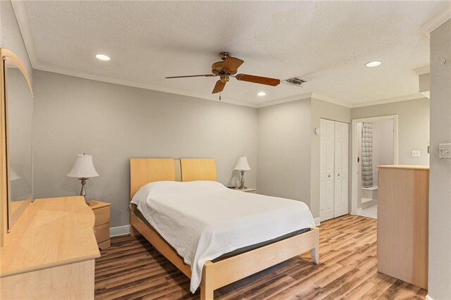 201 Avant Garde Cir Unit 201, Kenner, LA 70065 - bedroom with wood finished floors, crown molding, recessed lighting, a closet, and a ceiling fan
