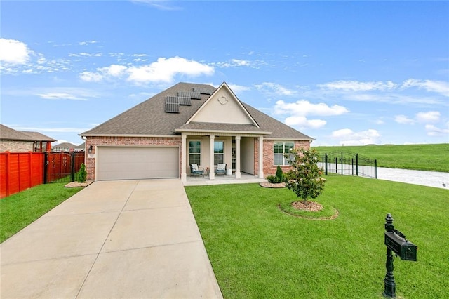 521 Lakeshore Village Ln, Slidell, LA 70461 - view of front facade with brick siding, an attached garage, driveway, solar panels, and a shingled roof