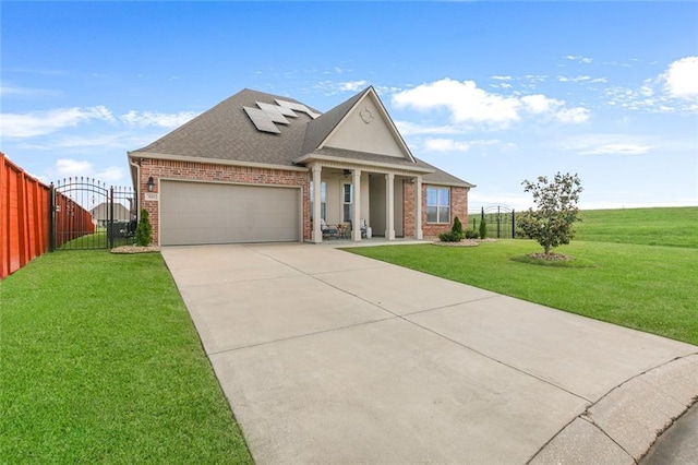 521 Lakeshore Village Ln, Slidell, LA 70461 - view of front of home with a gate, an attached garage, concrete driveway, roof with shingles, and brick siding