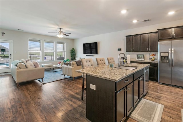 521 Lakeshore Village Ln, Slidell, LA 70461 - kitchen with stainless steel fridge, a sink, open floor plan, a breakfast bar area, and recessed lighting