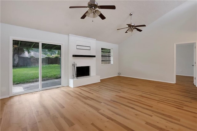 300 Somerset Dr, Slidell, LA 70461 - unfurnished living room featuring high vaulted ceiling, a large fireplace, light wood finished floors, a ceiling fan, and baseboards