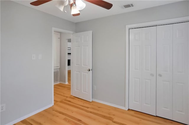 300 Somerset Dr, Slidell, LA 70461 - unfurnished bedroom featuring light wood-style flooring, baseboards, a closet, and ceiling fan