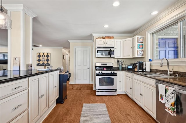 3425 Vincennes Pl, New Orleans, LA 70125 - kitchen with appliances with stainless steel finishes, a sink, dark countertops, ornamental molding, and light wood-style floors