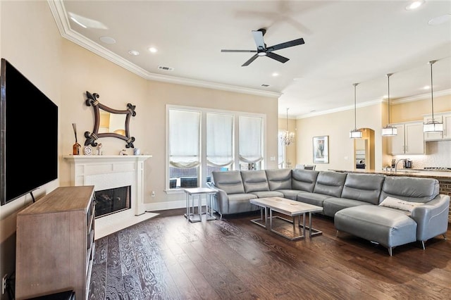 801 Rue Bourdeaux, Covington, LA 70433 - living room with a ceiling fan, dark wood finished floors, recessed lighting, a fireplace with flush hearth, and ornamental molding