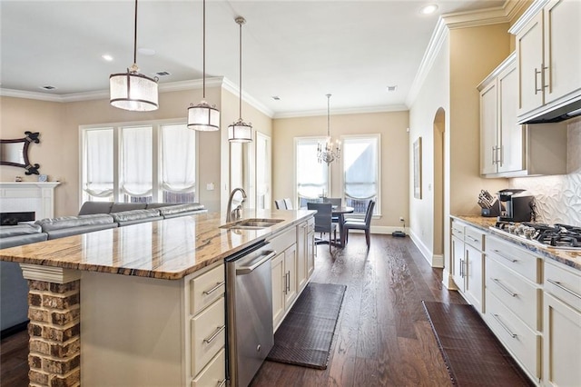 801 Rue Bourdeaux, Covington, LA 70433 - kitchen featuring a sink, appliances with stainless steel finishes, dark wood-style floors, arched walkways, and light stone countertops