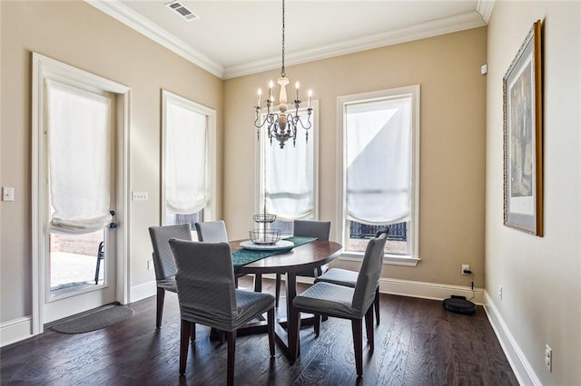 801 Rue Bourdeaux, Covington, LA 70433 - dining space with a chandelier, crown molding, baseboards, and dark wood-type flooring