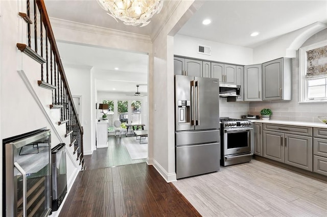 6951 Memphis St, New Orleans, LA 70124 - kitchen featuring gray cabinets, stainless steel appliances, wood finished floors, beverage cooler, and baseboards