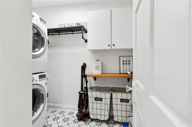 6951 Memphis St, New Orleans, LA 70124 - laundry area with stacked washer / dryer, cabinet space, and light floors